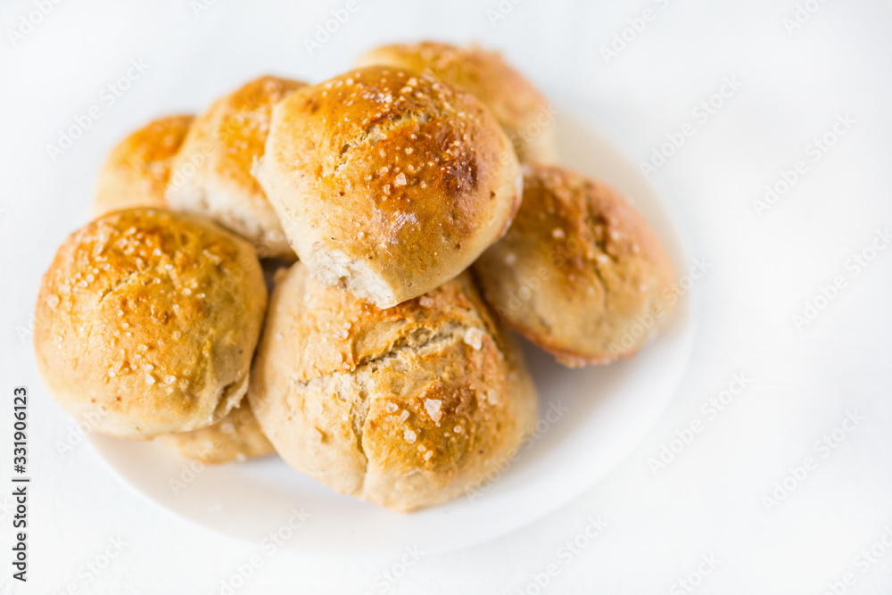Fresh salty bread buns pastry topped with salt