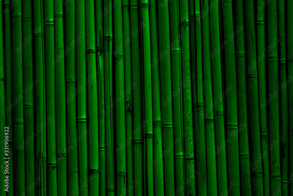 Naklejka Bamboo wall background. Dark green bamboo fence texture