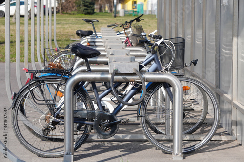 Modern Parking lot with a Bicycle roof near an apartment building with a large number of bicycles. Eco-friendly and sports transport in the city.