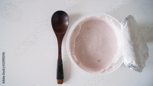 Blueberry yogurt on a white wooden table. Fresh yogurt. Healthy eating concept. High Resolution Product. View from above