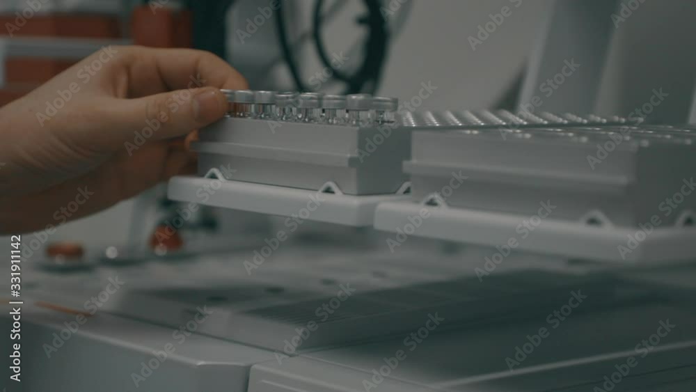 Scientists conducting research for medical vaccine to fight the COVID-19 virus amid corona pandemic. Closeup of people working in the laboratory. Scientists conducting research for medical vaccine to fight the COVID-19 virus amid corona pandemic. Closeup of people working in the laboratory.