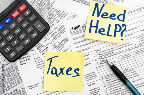 Need help and taxes text on stickers with tax forms. Assistance with filing tax form and calculation.