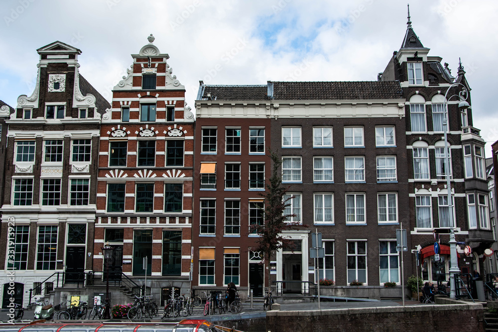 Cityscape of Amsterdam. Dutch city architecture. Modern exterior of buildings. Travel to Europe.