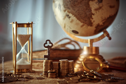 Old globe, coins, magnifying glass, keys to chests, rope, pirate map and marine logbook. Travel and marine prints background. The concept of a treasure hunter. Vintage style.