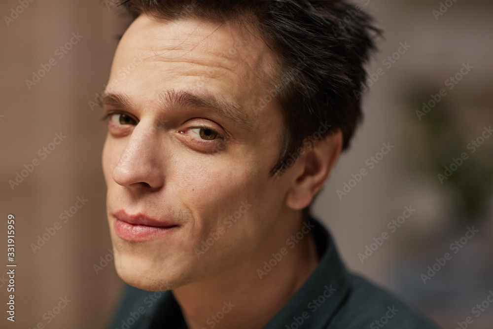Portrait of young handsome man with dark hair looking at camera Portrait of young handsome man with dark hair looking at camera