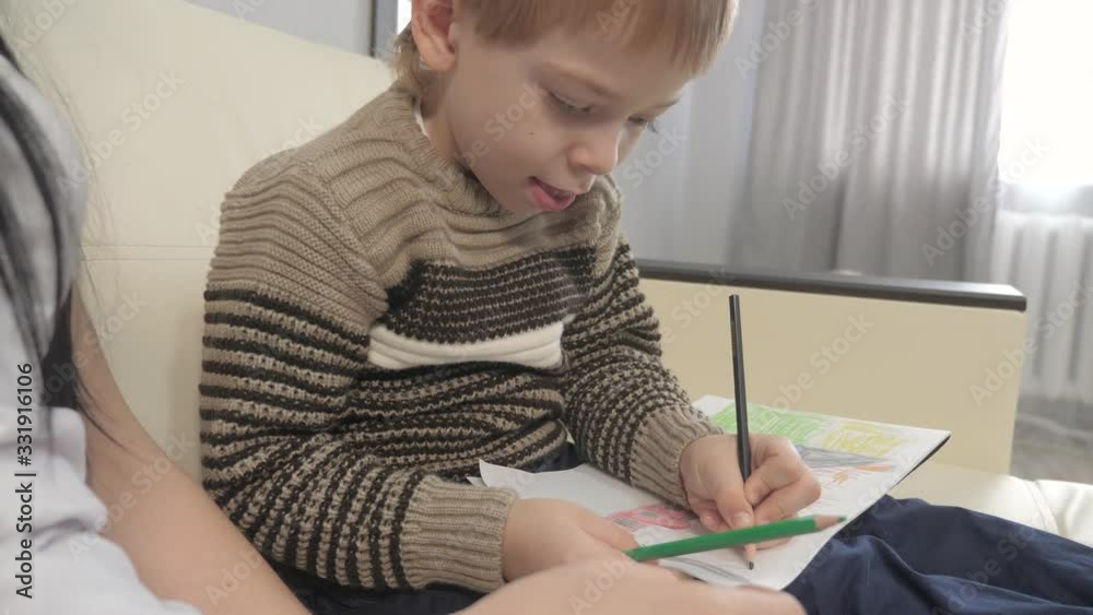 little boy draw happy family concept. child kid son with are engaged in pencil lifestyle drawing. lesson with children development of creativity