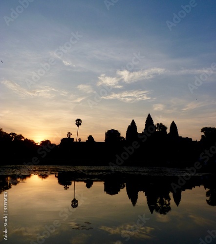 Angkor Wat during sunrise, shadows before lake with reflections, ruins of Angkor, Cambodia