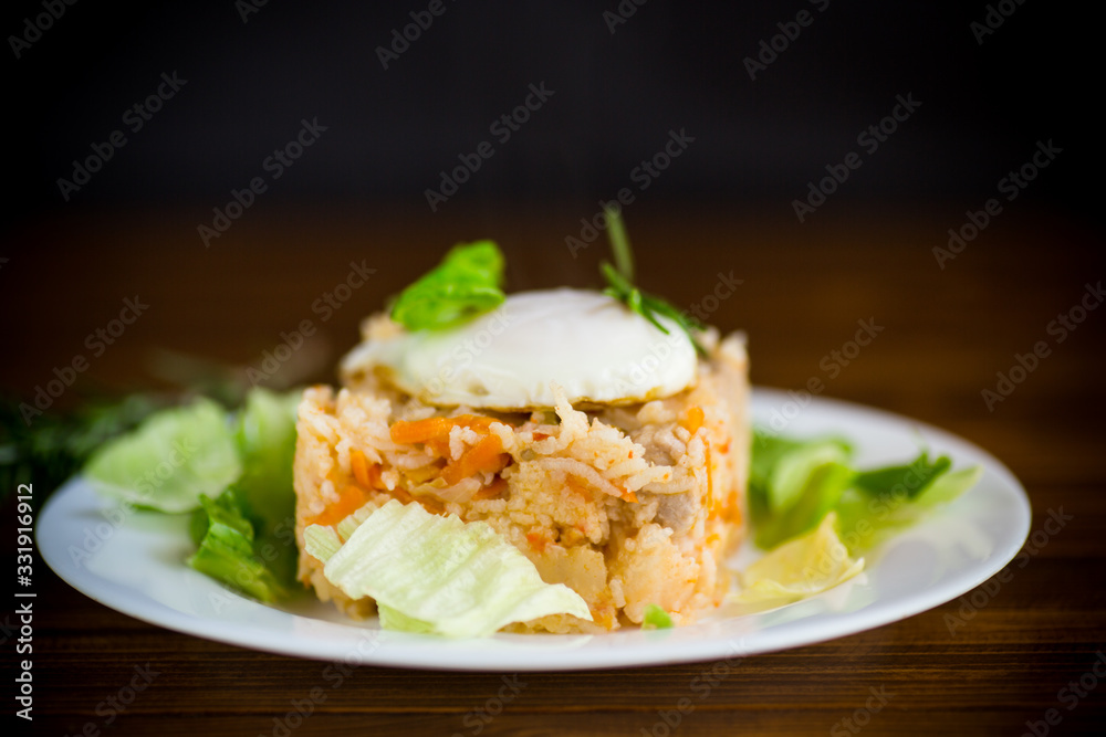 boiled rice with vegetables and fried egg with salad leaves in a plate boiled rice with vegetables and fried egg with salad leaves in a plate