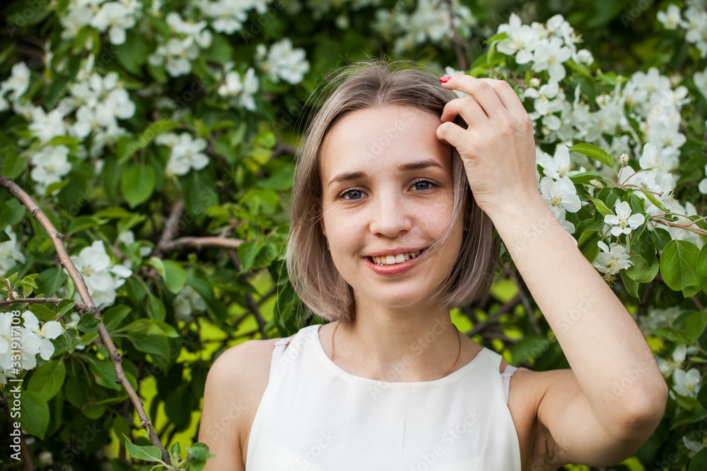 Happy woman in spring park, beautiful young face close up Happy woman in spring park, beautiful young face close up