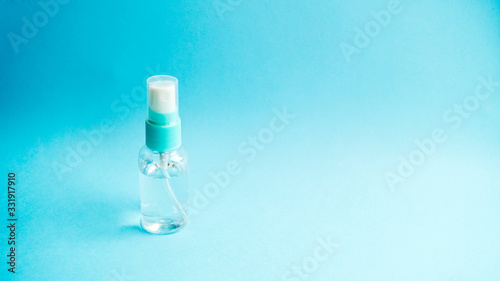 Antiseptic in the form of a spray in a bottle with a cap on a blue background. Prevention and protection against viruses. Healthcare and medicine. Coronavirus. Covid -19.