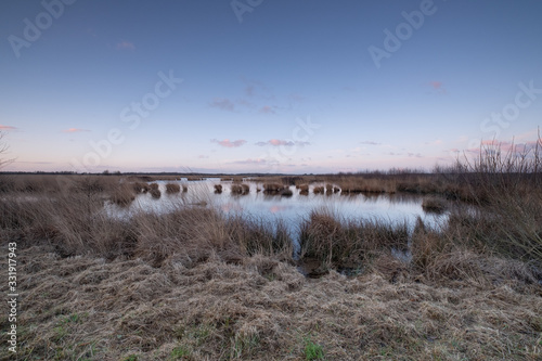 Landscape view sunset, water reflection, large nature reserve with peat soil, Fochteloerveen, The Netherlands