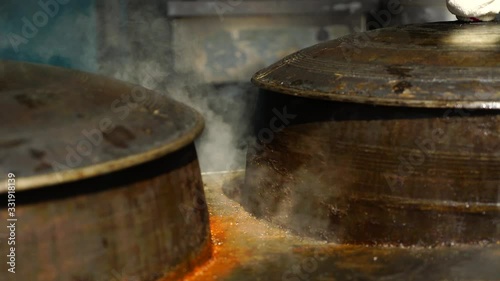 Traditional iron cooking pot boiling beef bone broth at Korean restaurant