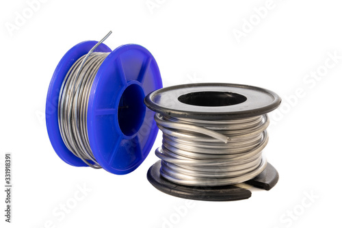 Solder wire spools made of tin and lead isolated on a white background