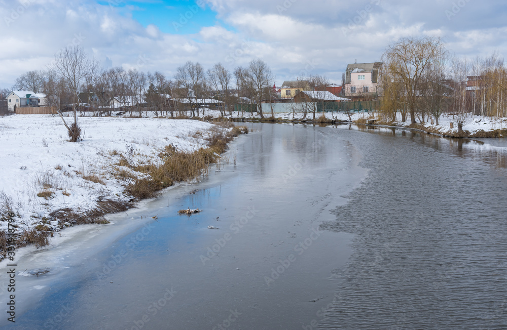 Winter landscape with half-frozen Sura river in Novo-Oleksadrivka village near Dnipro city, Ukraine