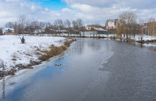 Winter landscape with half-frozen Sura river in Novo-Oleksadrivka village near Dnipro city, Ukraine