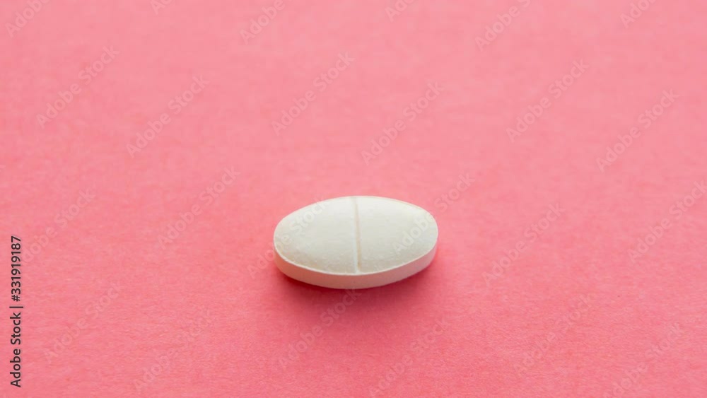 Different pills sequence. Stopmotion of few different pills on pink background Different pills sequence. Stopmotion of few different pills on pink background