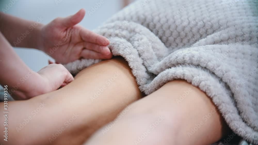 Massage - masseuse massaging the hips of a slender woman with a special massage technique Massage - masseuse massaging the hips of a slender woman with a special massage technique