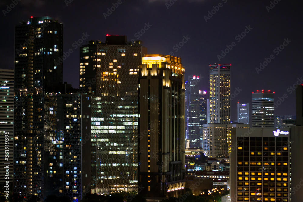 Night city background, with glowing windows in houses