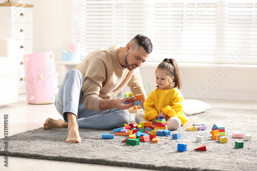 Father playing with his child at home