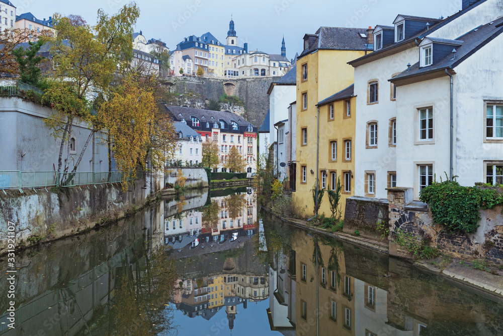 Detail of famous Luxembourg city line in evening with Saint Michael Cathedral and water reflections, Luxembourg.