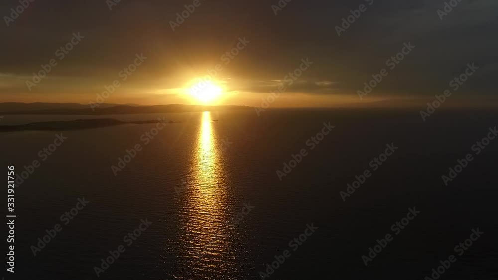 Scenic coast on a warm dramatic summer sunset. Aerial view. Scenic coast on a warm dramatic summer sunset. Aerial view.