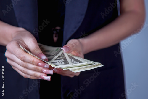 Business woman holding US Dollar banknotes. Money, wealth, work, salary concept