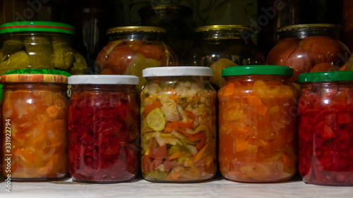 Vászonkép Pantry shelf with provisions in glass jars with pickled vegetables