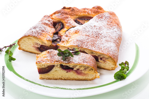 sweet baked homemade plum cake with icing sugar