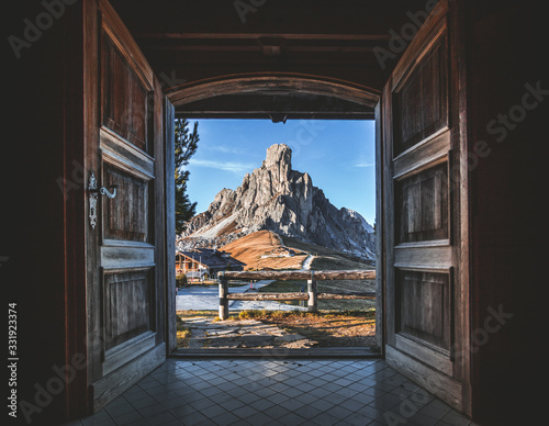 Fantastic view over Giau Pass from interior of famous wooden chalet. Open doors and beautiful view over Dolomites in SouthTyrol, Italy
