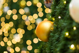 Christmas ball decor on tree and light background.