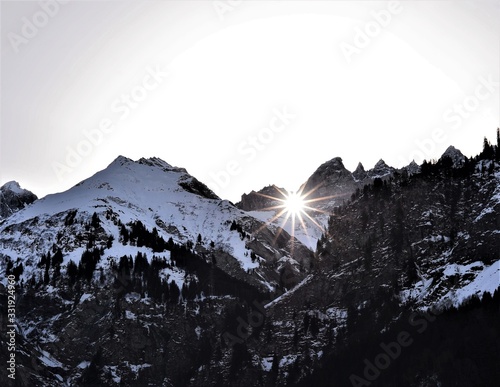sun shines through the martinsloch in winter in elm