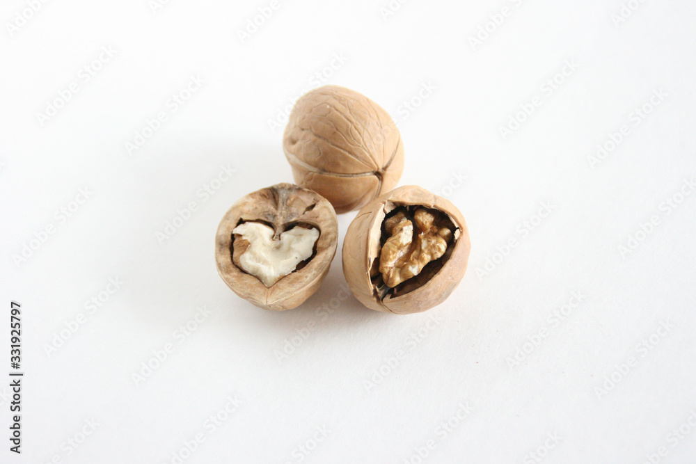 Walnuts on white table. Food background with copyspace Walnuts on white table. Food background with copyspace