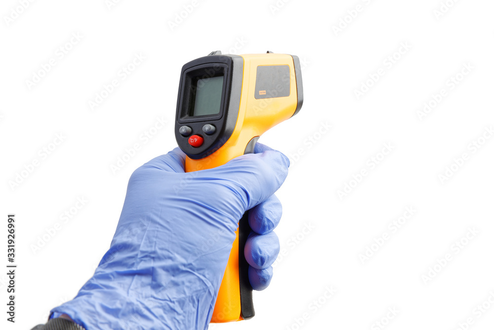Closeup hand in a blue medical glove holds an digital infrared thermometer. Isolated on white background.
