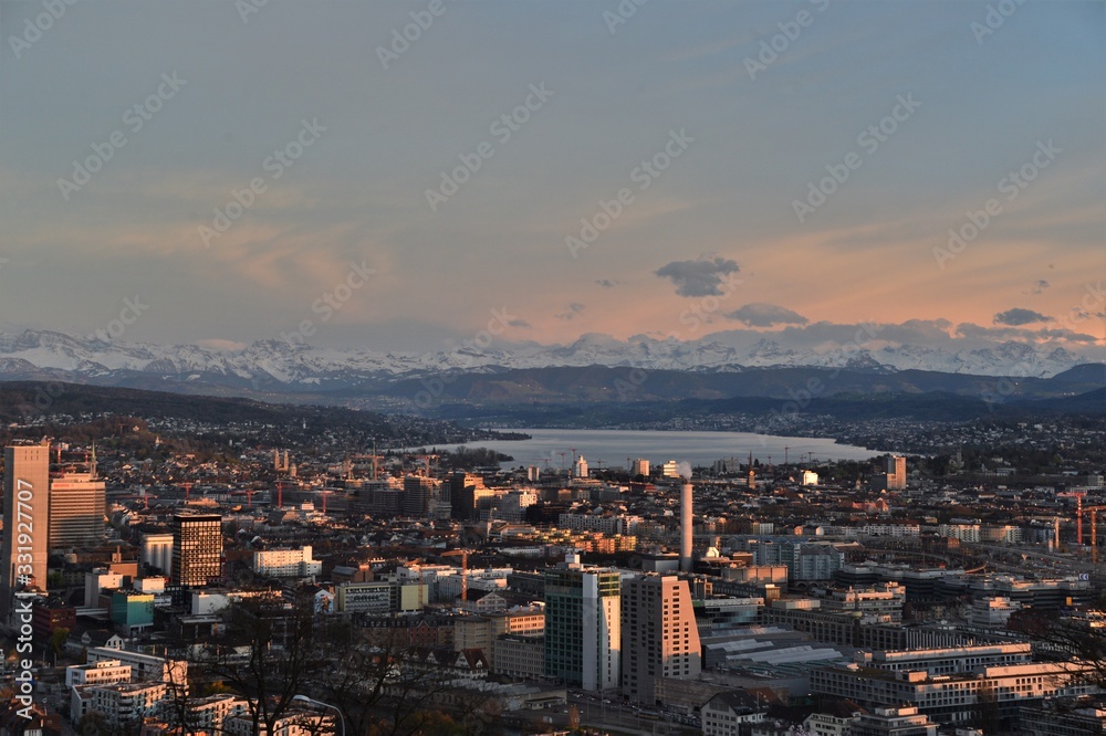 the city of zurich switzerland seen from the waid in the evening mood