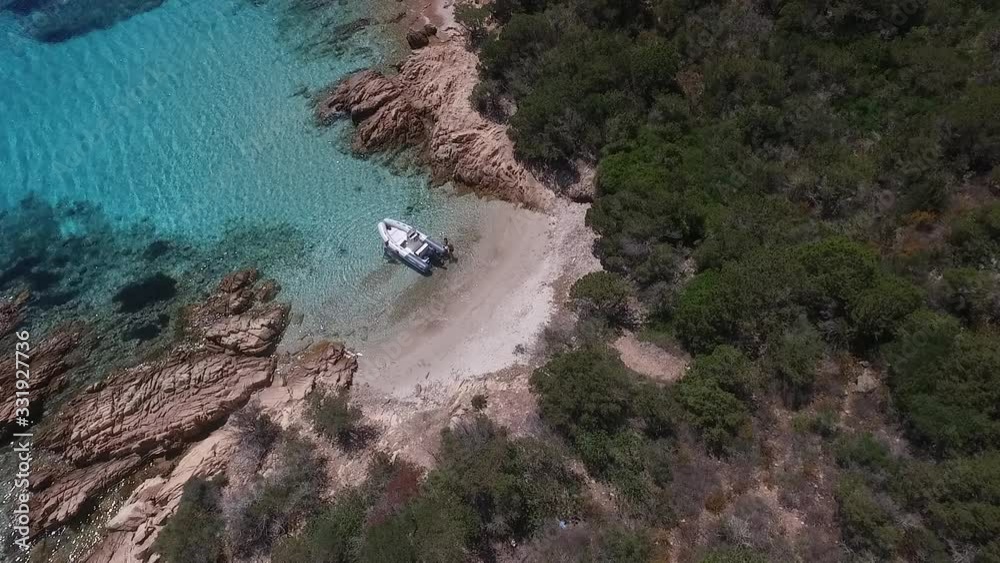 People and their motorboat. Anchoring boat in the bay of tropical sea. Colorful landscape with boat, bay, clear azure water. Top view from air. Seascape with motorboat. People and their motorboat. Anchoring boat in the bay of tropical sea. Colorful landscape with boat, bay, clear azure water. Top view from air. Seascape with motorboat.