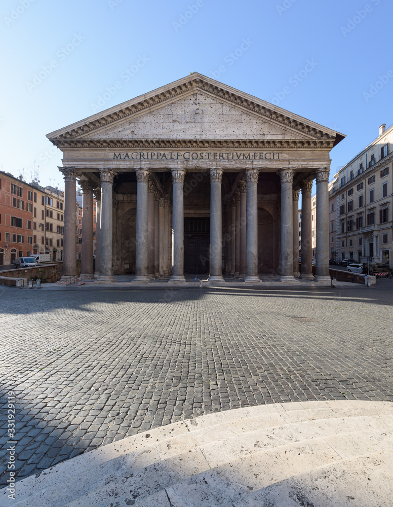 People wearing face masks cross empty squares in front of monuments, Rome, Italy