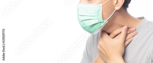 Closeup Young Man in hygienic mask suffering sore throat, 2019-nCoV or coronavirus. Airborne respiratory illness such as pm 2.5 fighting and flu isolated on white background. Banner size. © Touchr