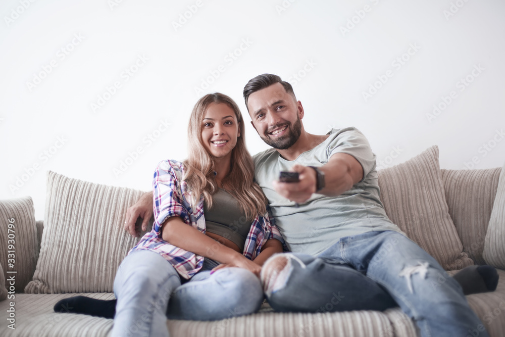 Young couple enjoying themselves on the sofa in the living room Young couple enjoying themselves on the sofa in the living room