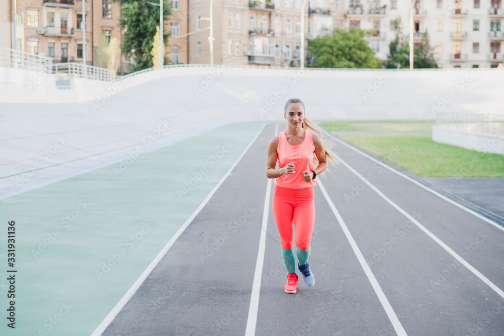 Sports and fitness outside the gym. Young fit woman with perfect body in sportswear trains outdoors on the playground. Sportive and healthy lifestyle, street work out, training, exercise concept.