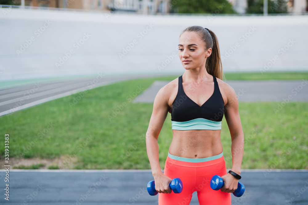 Sports and fitness outside the gym. Young fit woman with perfect body in sportswear trains outdoors on the playground. Sportive and healthy lifestyle, street work out, training, exercise concept. Sports and fitness outside the gym. Young fit woman with perfect body in sportswear trains outdoors on the playground. Sportive and healthy lifestyle, street work out, training, exercise concept.