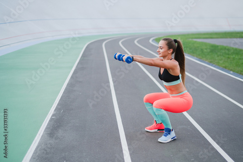 Sports and fitness outside the gym. Young fit woman with perfect body in sportswear trains outdoors on the playground. Sportive and healthy lifestyle  street work out  training  exercise concept.