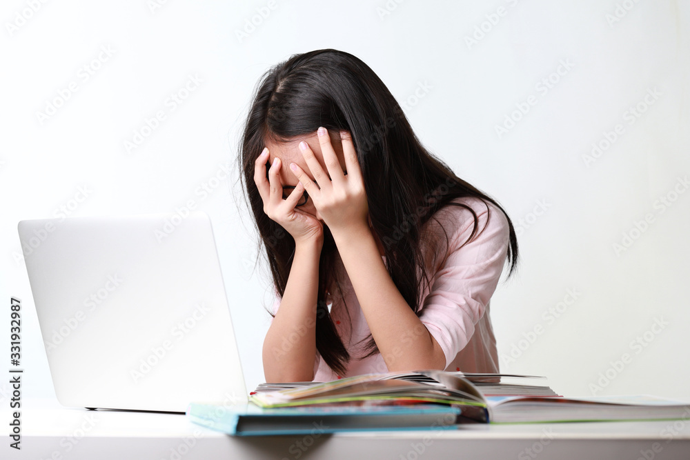 Portrait of frustrated worried young asian girl looks at laptop upset by bad news, negative bullying message, troubled with problem online or email notification.