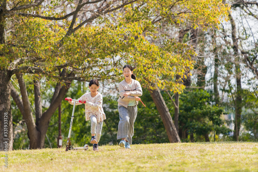 春の公園で遊んでいる可愛い子供姉妹 春の公園で遊んでいる可愛い子供姉妹