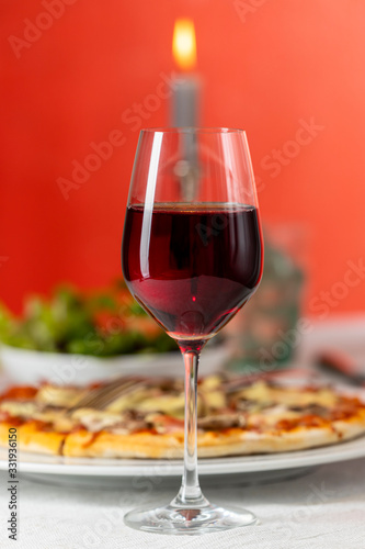 pizza with red wine and a candle