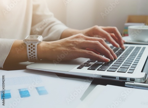 Slika na platnu Asian woman is typing on keyboard of laptop or computer notebook for check elect