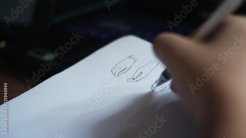 Artists hands drawing  pencil sketching hand on the paper