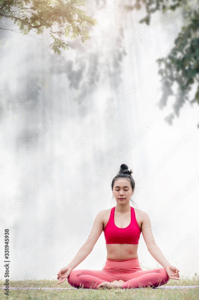 Calm brunette doing yoga asana in the park with sunlight and fog background. Calm brunette doing yoga asana in the park with sunlight and fog background.