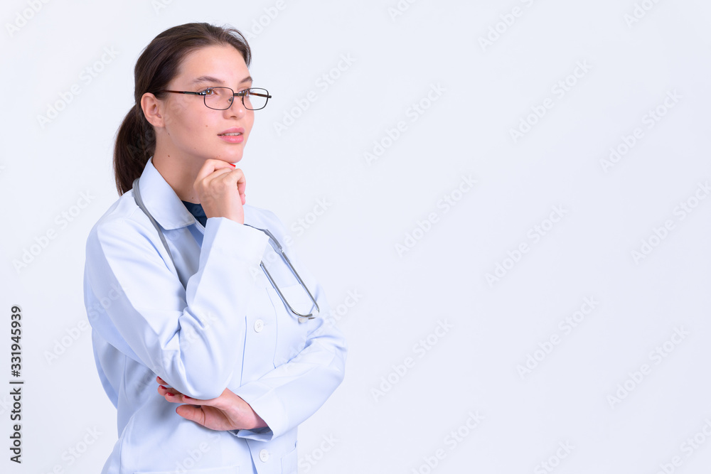 Portrait of young beautiful woman doctor thinking Portrait of young beautiful woman doctor thinking