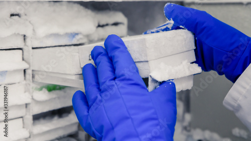 Scientific manipulating tests in bioscience laboratory freezer. Concept of science, laboratory and study of diseases. Coronavirus (COVID-19) treatment developing.