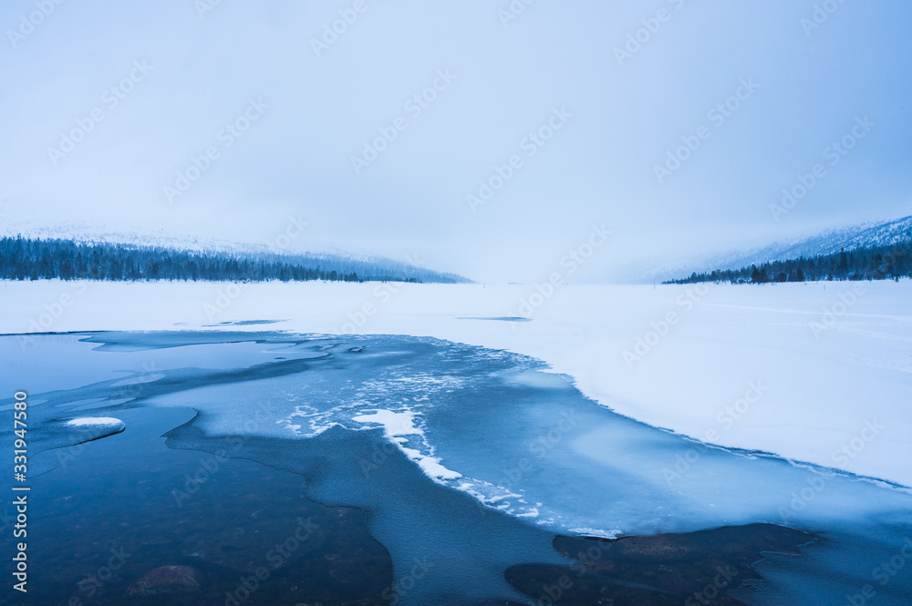 Ice formations on frozen lake in winter, Sweden.